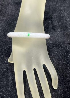 Translucent white jadeite round bangle with a natural green dot accent