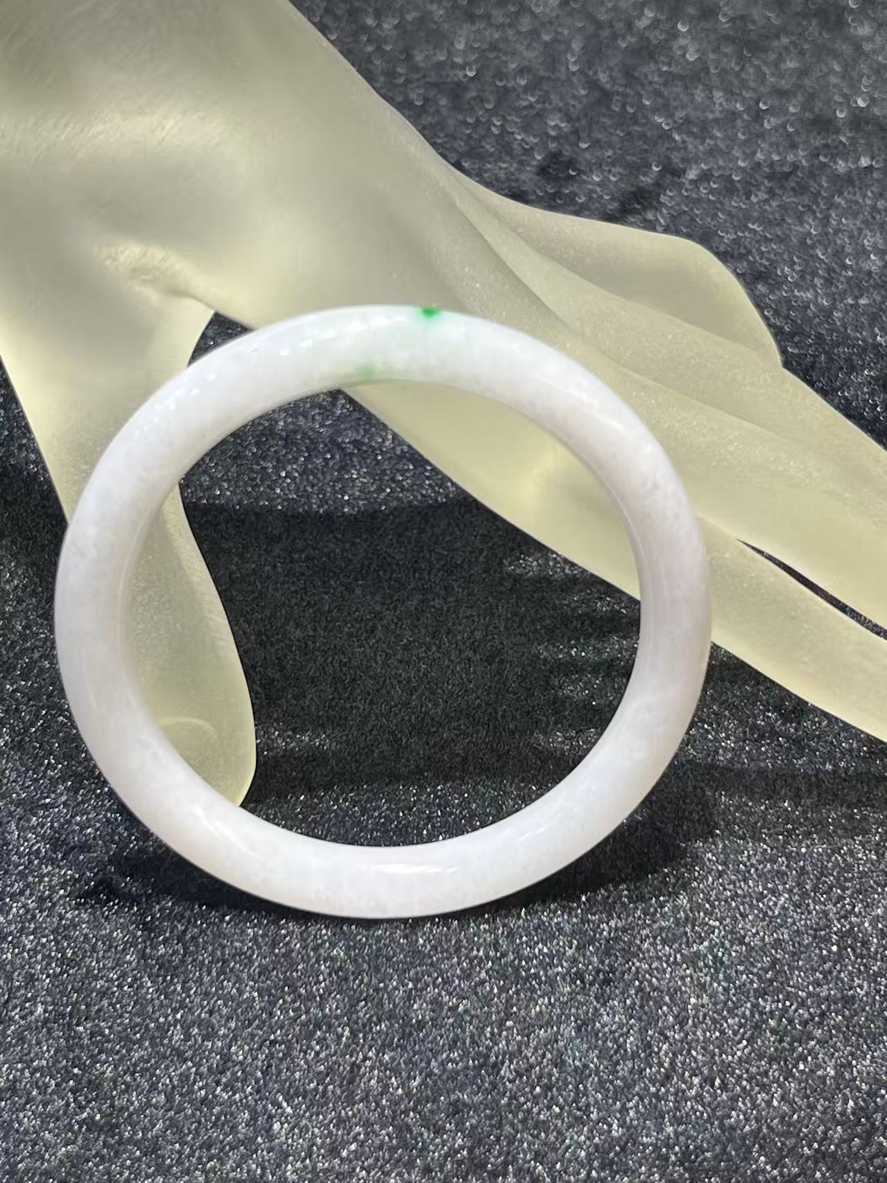 Translucent white jadeite round bangle with a natural green dot accent