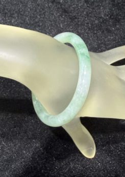 Translucent pale green and white jadeite bangle with smooth polished finish