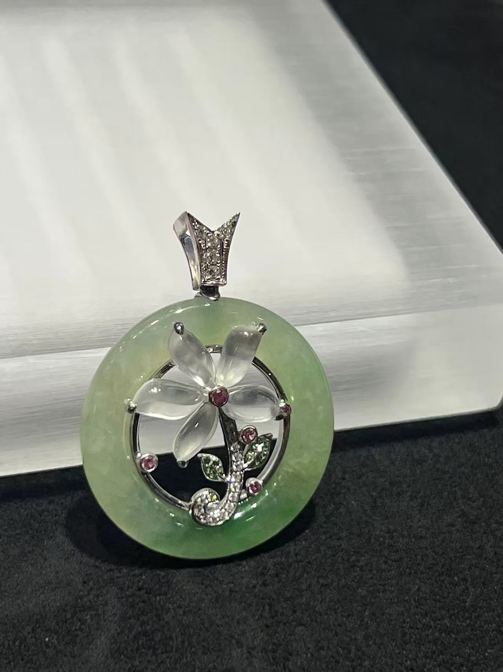 Translucent floral jadeite pendant with icy jade flower and green circular jade set in 18K white gold