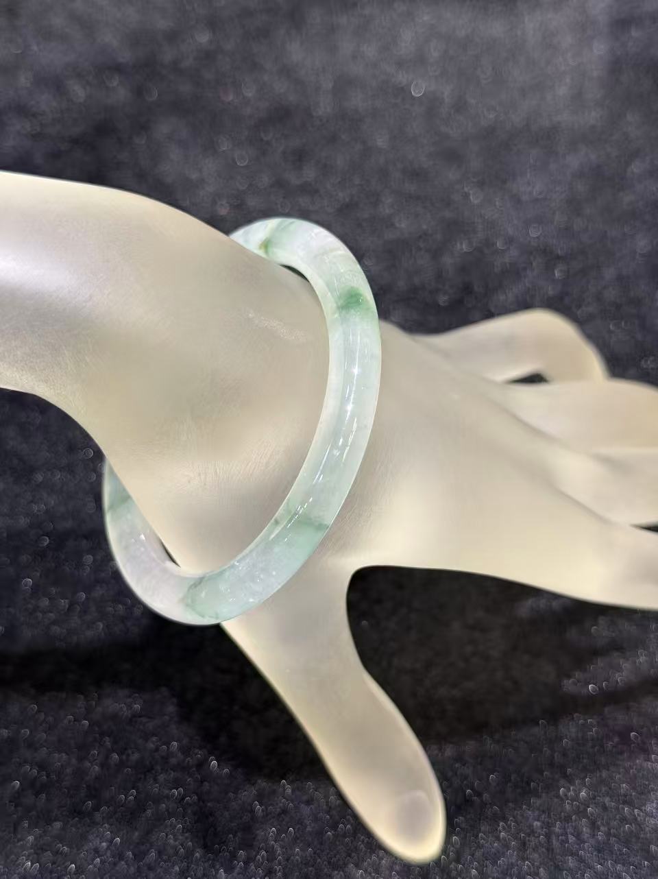 Natural Type A icy translucent jadeite bangle with floral green floating patterns