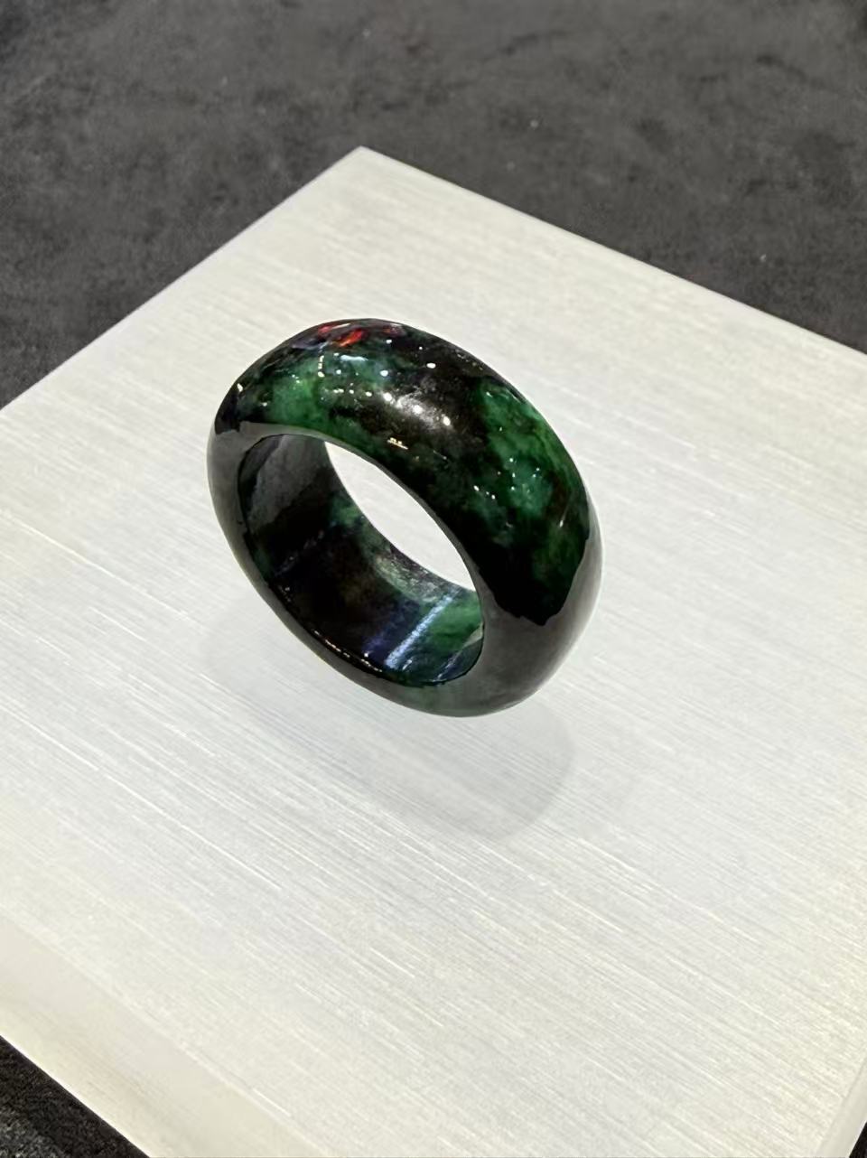 Translucent dark green natural Type A jadeite ring with deep forest green tones