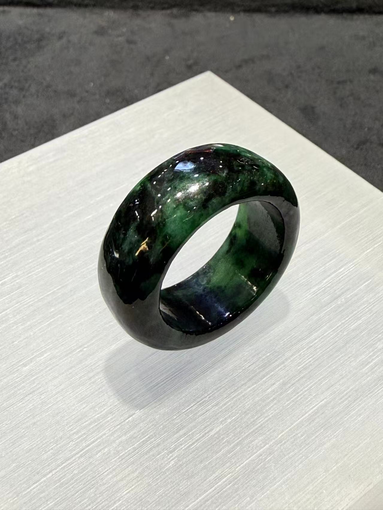 Translucent dark green natural Type A jadeite ring with deep forest green tones