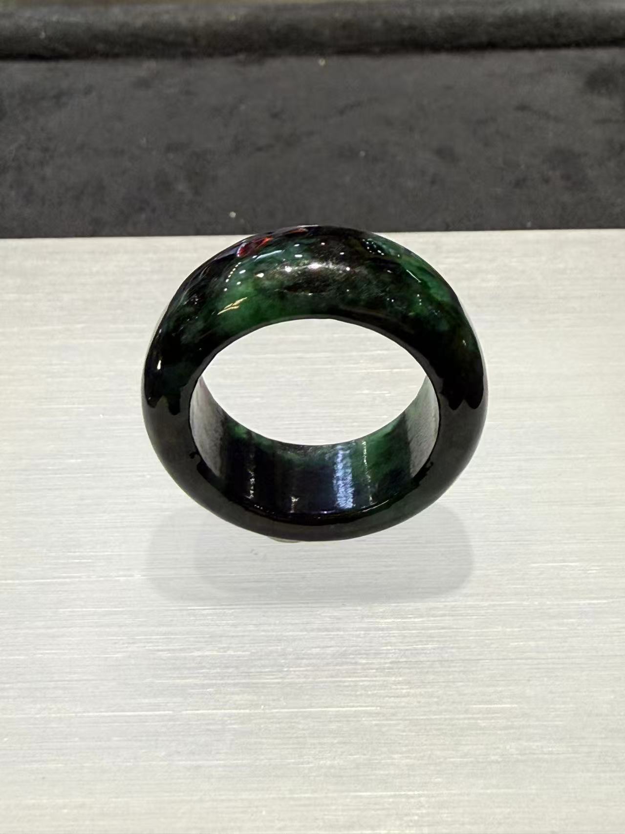 Translucent dark green natural Type A jadeite ring with deep forest green tones