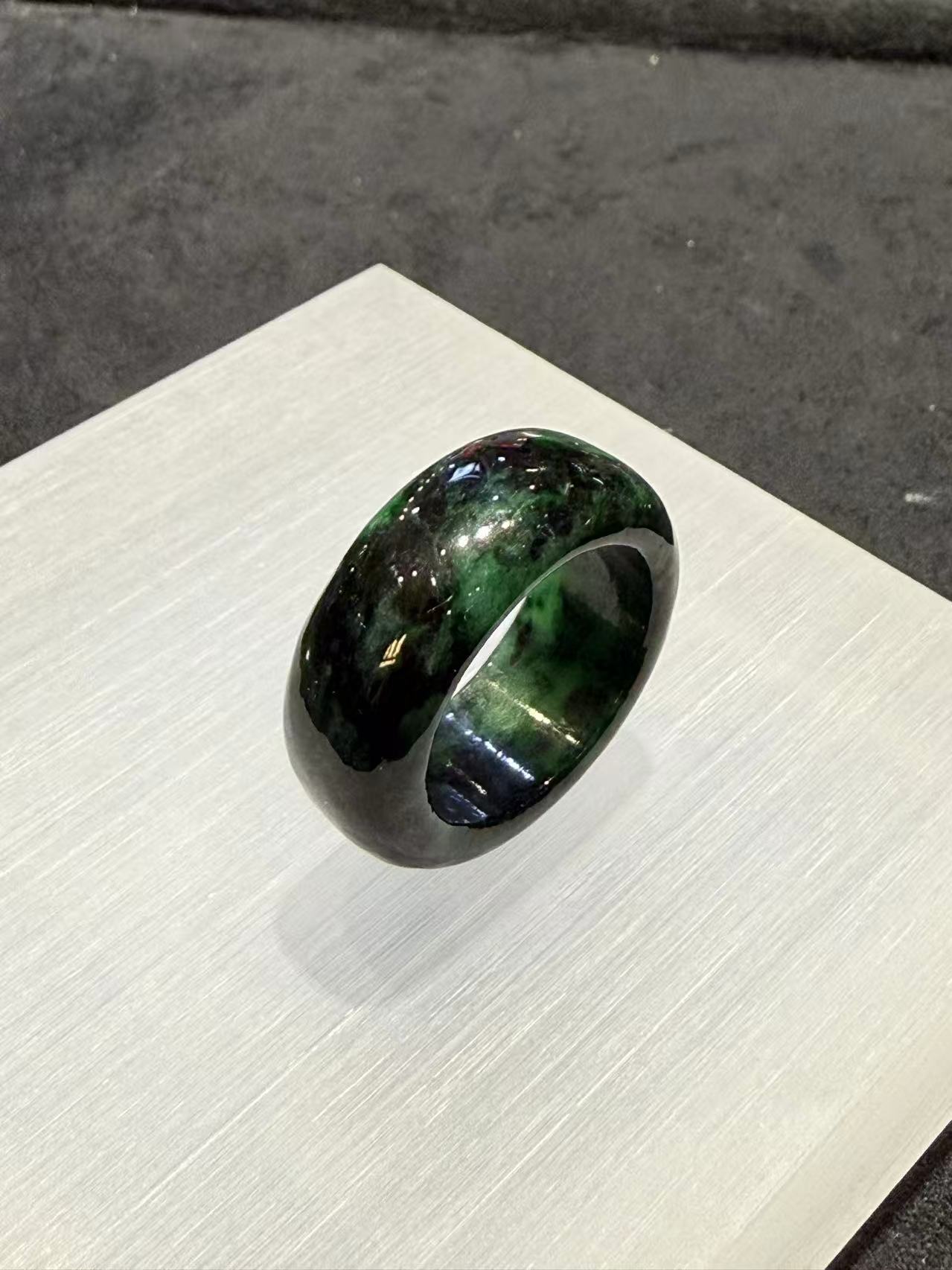 Translucent dark green natural Type A jadeite ring with deep forest green tones