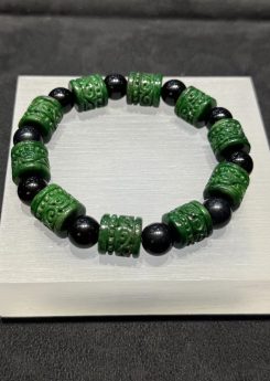 translucent dark green Ruyi jadeite bracelet with carved beads and black bead accents