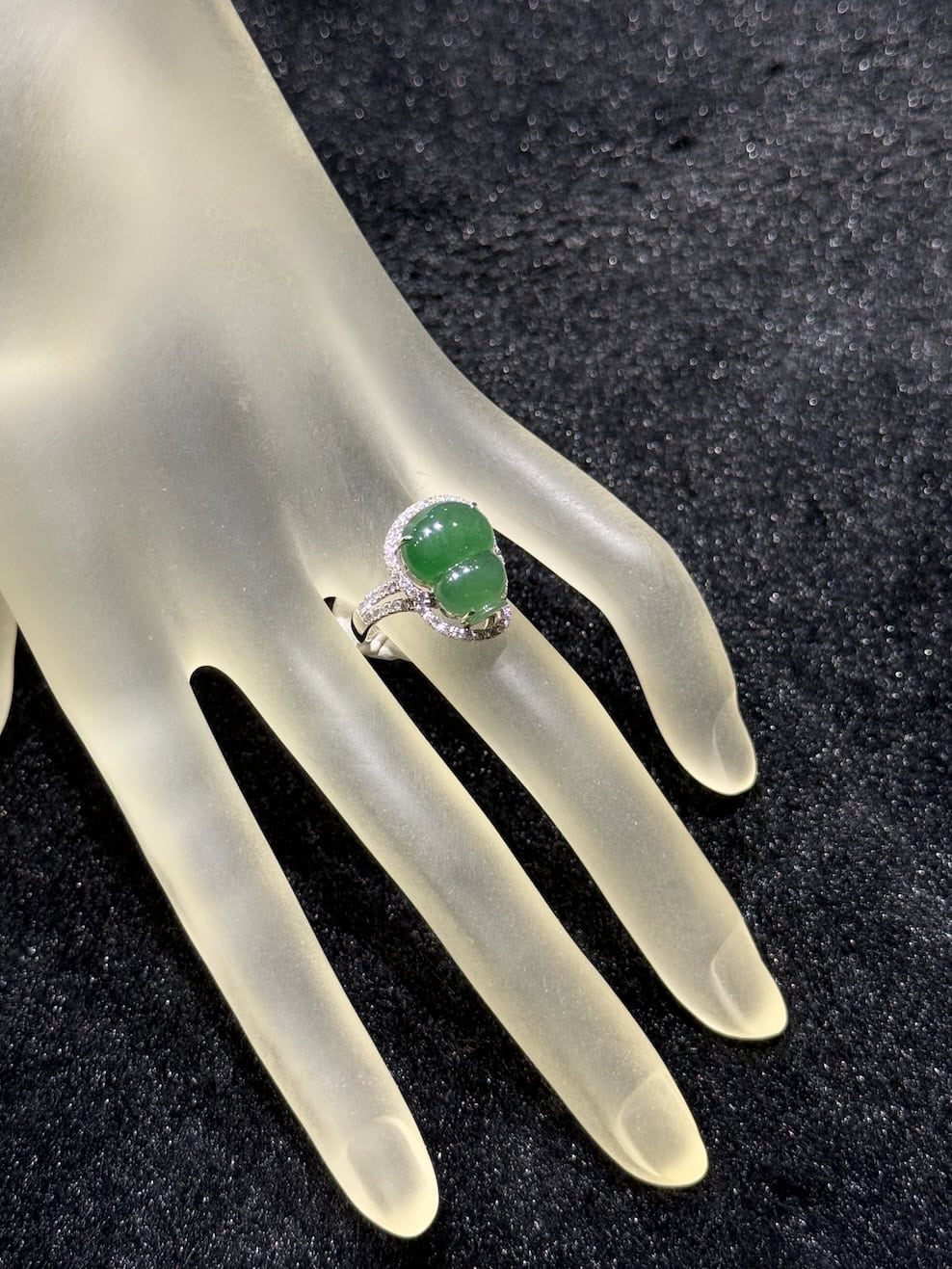 Jade gourd ring carved from icy translucent dark green jadeite, set in 18k white gold with a diamond halo and diamond-set shoulders