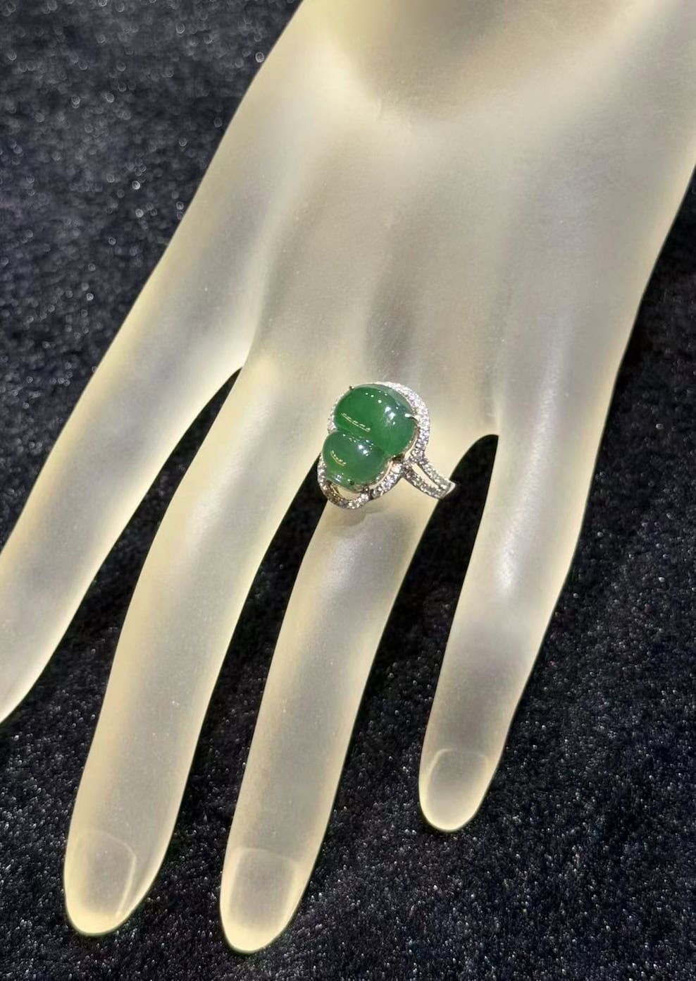 Jade gourd ring carved from icy translucent dark green jadeite, set in 18k white gold with a diamond halo and diamond-set shoulders