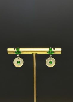 Pair of jade drop earrings with highly translucent icy jadeite safety-buckle discs and vibrant green jadeite cabochons, set in 18k white gold with diamonds