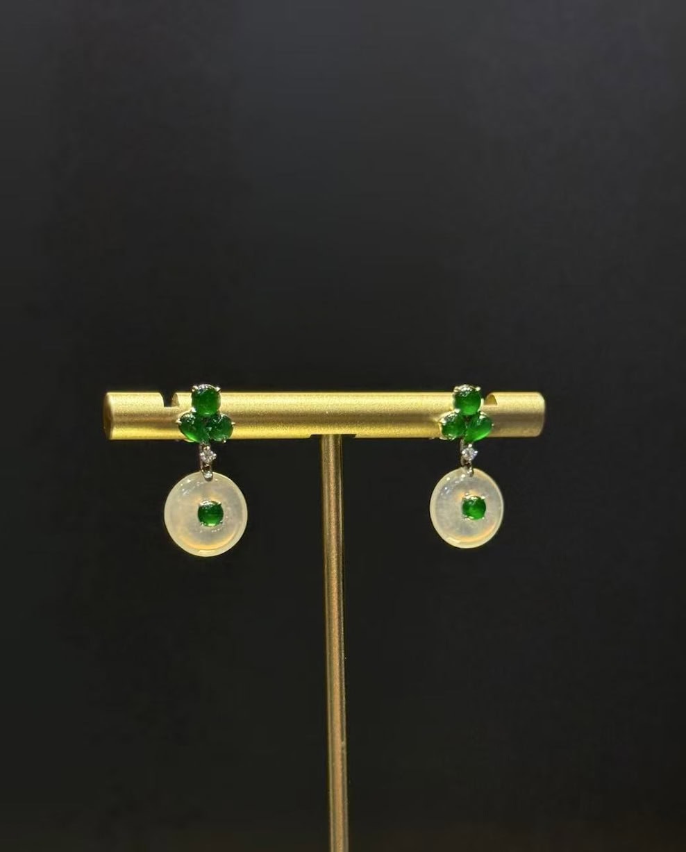 Pair of jade drop earrings with highly translucent icy jadeite safety-buckle discs and vibrant green jadeite cabochons, set in 18k white gold with diamonds