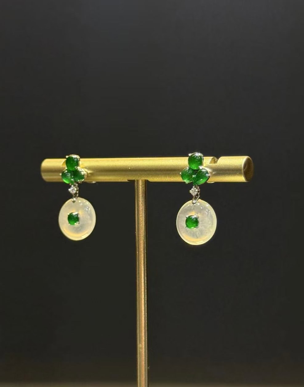 Pair of jade drop earrings with highly translucent icy jadeite safety-buckle discs and vibrant green jadeite cabochons, set in 18k white gold with diamonds