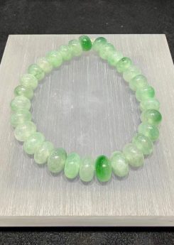 Jadeite abacus bracelet of icy, translucent jadeite beads with patches of vibrant green floating across the strand