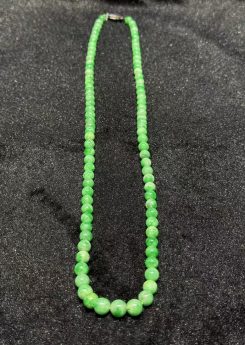 Apple green jadeite necklace strung with round translucent vibrant apple-green jadeite beads, graduated from small at the top to larger toward the front