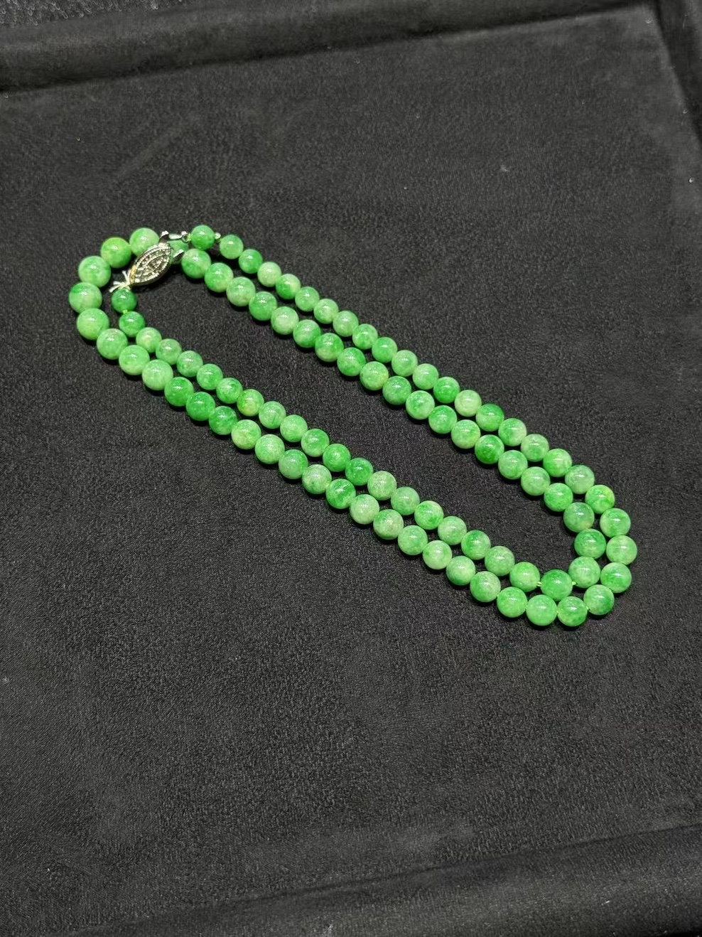 Apple green jadeite necklace strung with round translucent vibrant apple-green jadeite beads, graduated from small at the top to larger toward the front