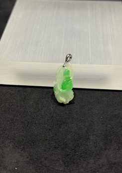 Ruyi jade pendant carved from translucent icy white and vibrant green jadeite, with a curling ruyi head and small flower bud details, hung from a 18k white gold bail