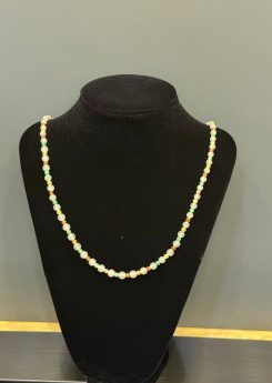 Multi-colour jadeite necklace strung with icy translucent jadeite beads and smaller vibrant green, yellow, and orange-red jade spacer beads