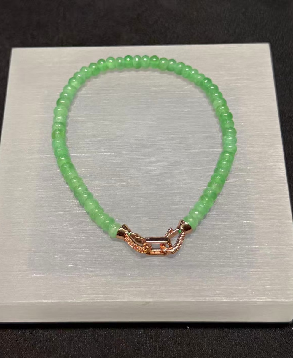 Apple green abacus jade bracelet strung with small icy translucent vibrant apple green jadeite abacus beads, finished with a brass clasp at the back