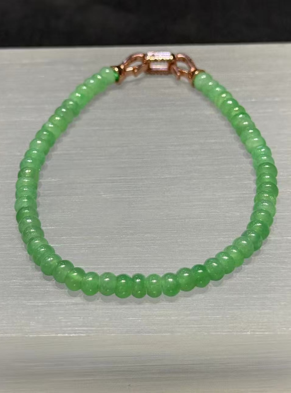 Apple green abacus jade bracelet strung with small icy translucent vibrant apple green jadeite abacus beads, finished with a brass clasp at the back