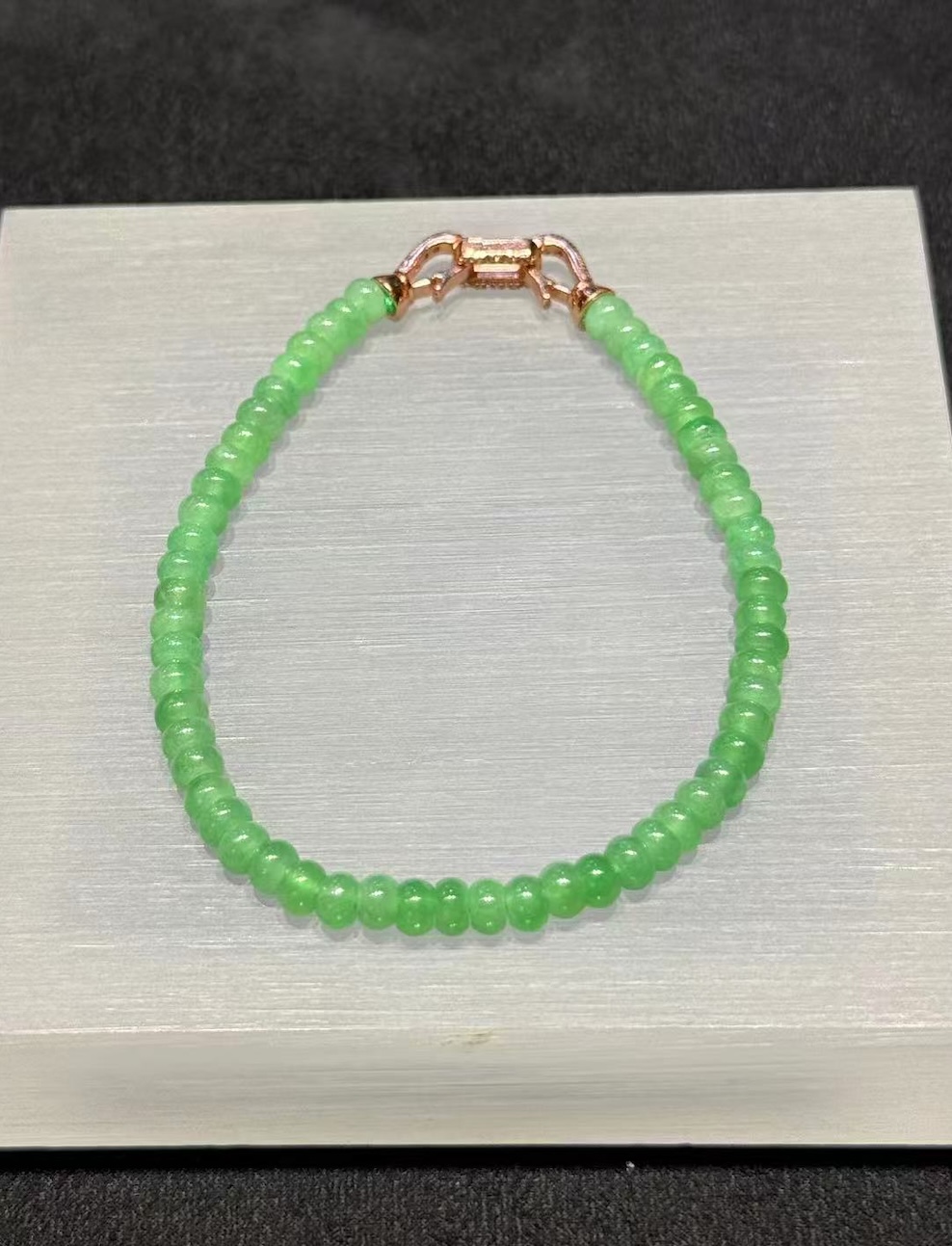 Apple green abacus jade bracelet strung with small icy translucent vibrant apple green jadeite abacus beads, finished with a brass clasp at the back