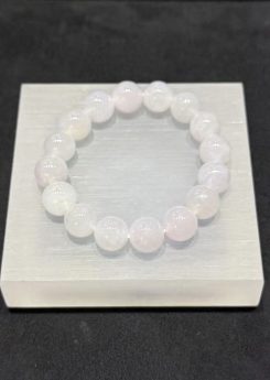 Lavender jade bracelet strung with round icy translucent jadeite beads in a whiteish body with a very faint lavender tint