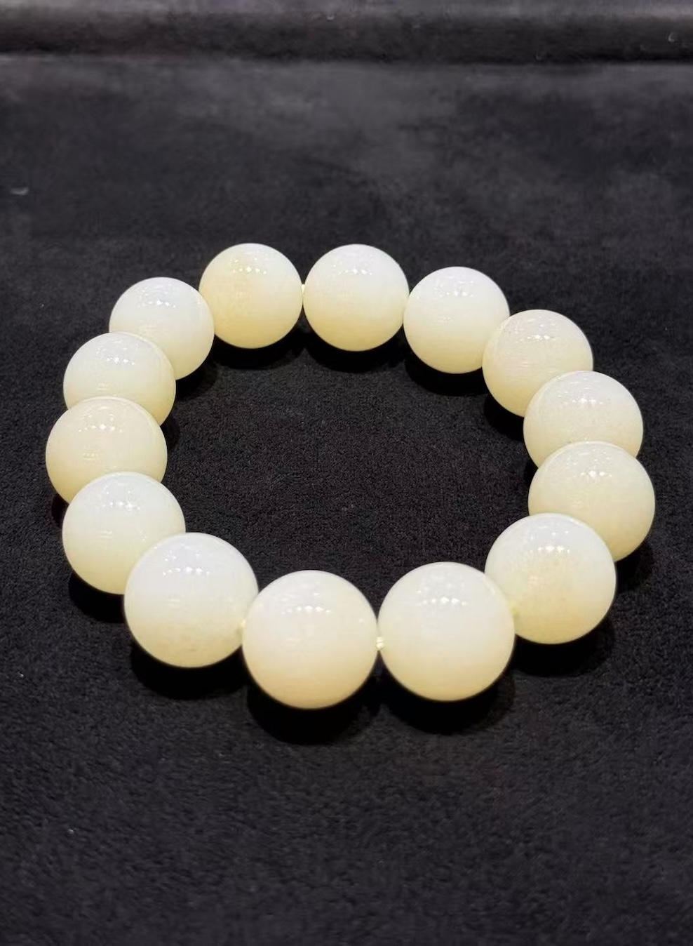 White nephrite bracelet strung with round natural nephrite beads in a soft, creamy white tone with a gentle waxy lustre