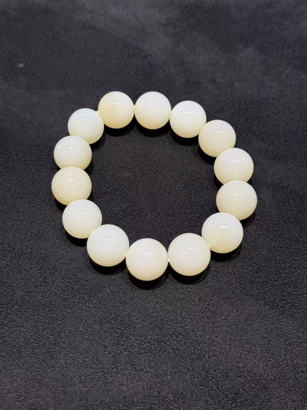 White nephrite bracelet strung with round natural nephrite beads in a soft, creamy white tone with a gentle waxy lustre