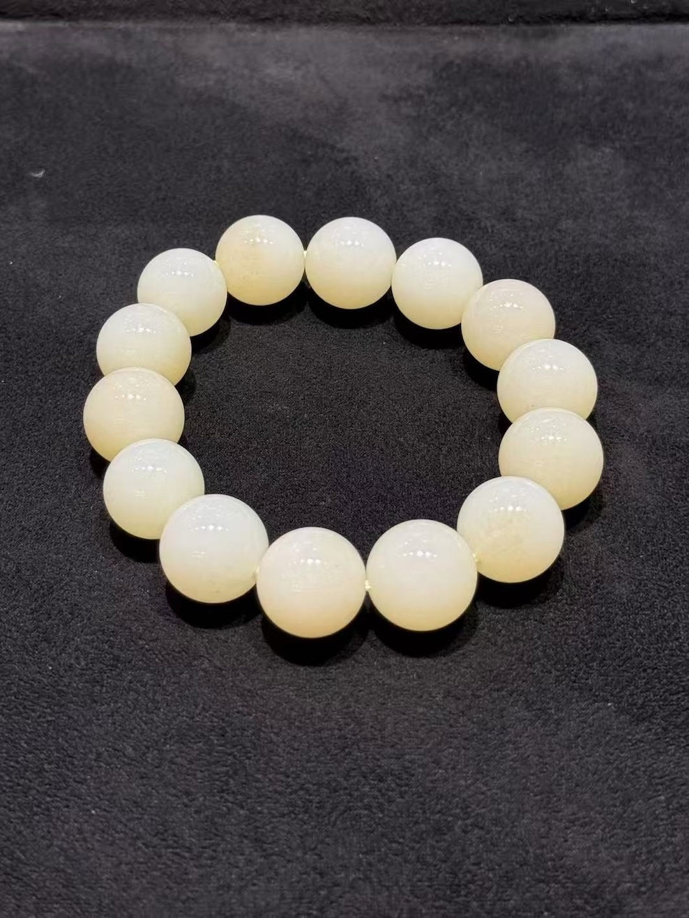 White nephrite bracelet strung with round natural nephrite beads in a soft, creamy white tone with a gentle waxy lustre