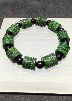 translucent dark green Ruyi jadeite bracelet with carved beads and black bead accents