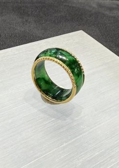 Green jadeite diamond ring in a deep translucent old pit green, set with a channel of small diamonds around the middle and lined with 18k yellow gold on the inside