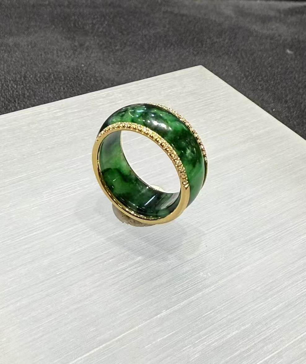 Green jadeite diamond ring in a deep translucent old pit green, set with a channel of small diamonds around the middle and lined with 18k yellow gold on the inside