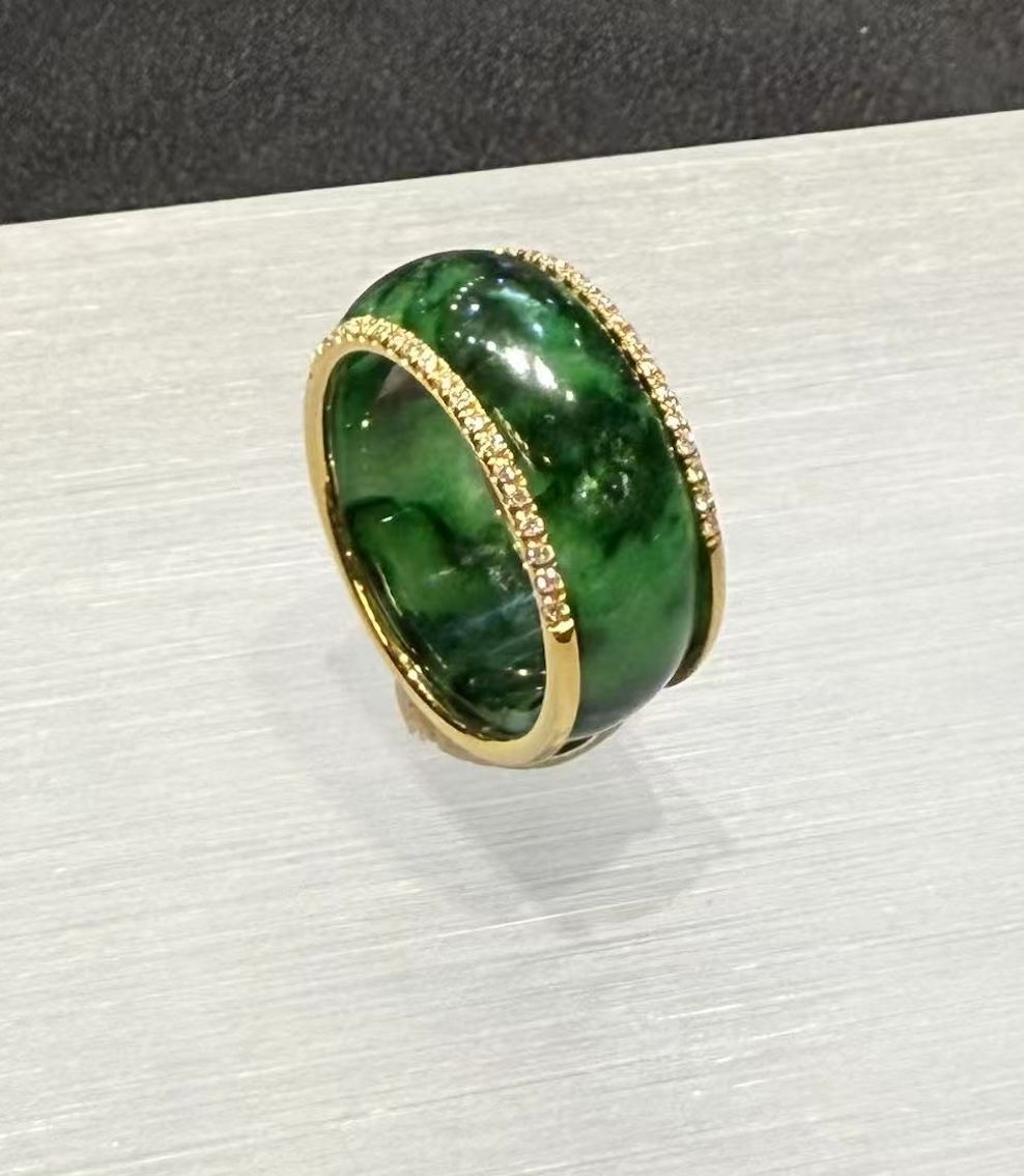Green jadeite diamond ring in a deep translucent old pit green, set with a channel of small diamonds around the middle and lined with 18k yellow gold on the inside