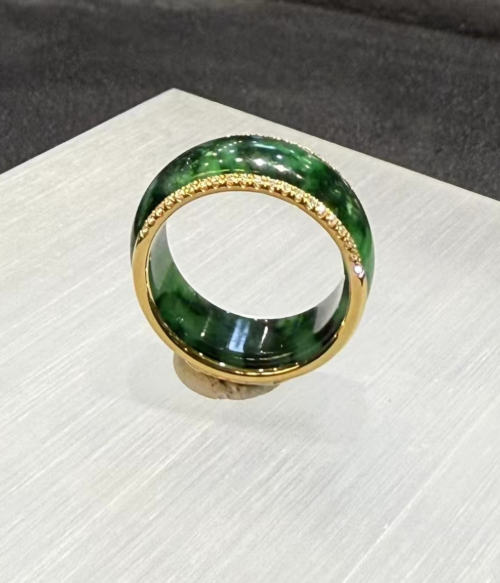 Green jadeite diamond ring in a deep translucent old pit green, set with a channel of small diamonds around the middle and lined with 18k yellow gold on the inside