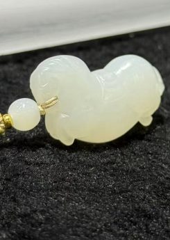 Jade horse pendant hand-carved from creamy white nephrite in the traditional Chinese Tang horse (唐马) style, hung from a small braided cord with a jade bead